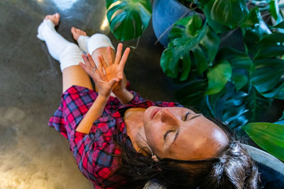 High angle view of woman lying down outdoors