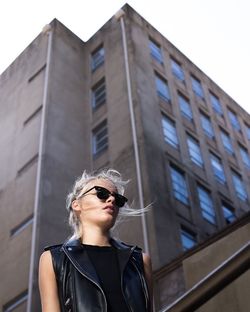 Low angle view of woman standing in city