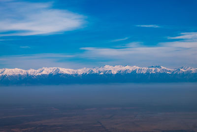 Scenic view of snowcapped mountains against sky