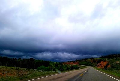 Country road against sky