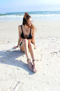 Full length of woman on beach against sky