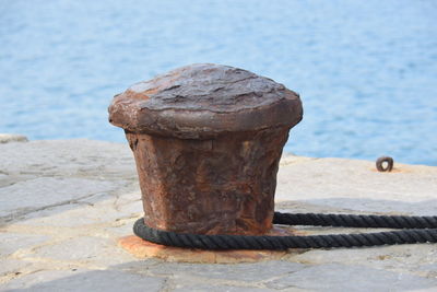 Rope tied to bollard on pier