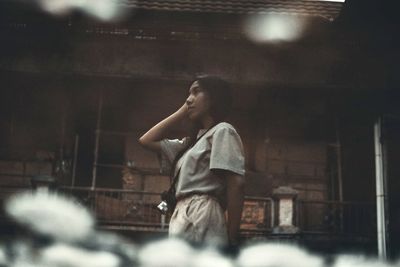 Side view of woman looking at camera at night