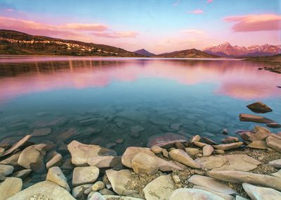 Scenic view of lake against sky during sunset