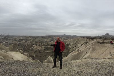 Full length of man standing on landscape against sky