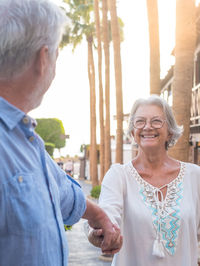 Portrait of smiling couple standing in city