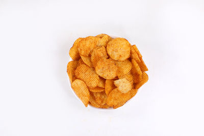 High angle view of orange cookies against white background