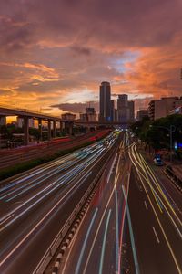 High angle view of light trails on highway against sky during sunset