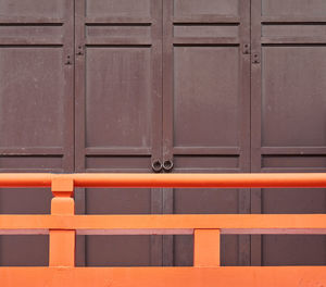 Full frame shot of closed door and railing of wooden building