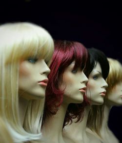 Close-up of mannequins with wigs at store