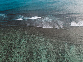 High angle view of waves rushing towards shore