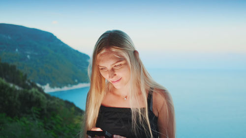 Portrait of beautiful woman against sky