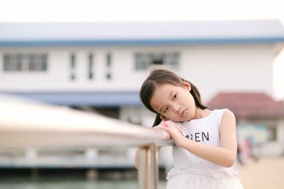 Portrait of smiling girl standing against blurred background
