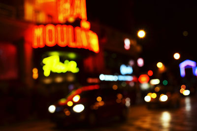 Defocused image of illuminated lights in city at night