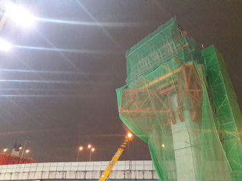 Low angle view of illuminated building against sky at night