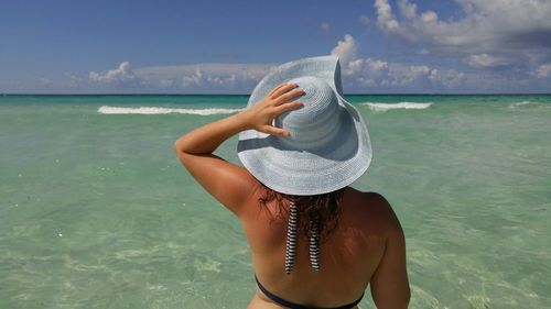 Rear view of woman standing on beach