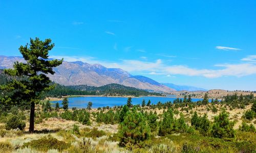 Scenic view of mountains against blue sky