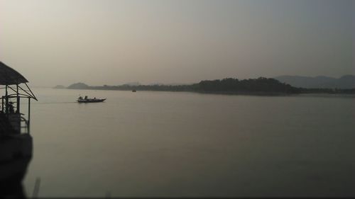 View of boats in sea at sunset