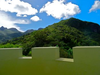 Scenic view of mountains against cloudy sky