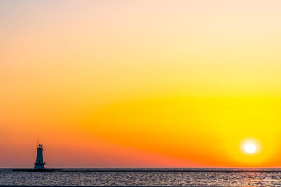 Scenic view of sea against orange sky