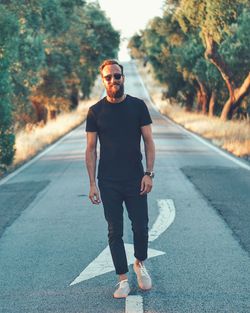 Full length of young man walking on road