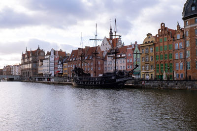 Beautiful old town of gdansk over motlawa river vintage ship pirate caravels sailing on motlawa