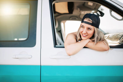 Smiling woman sitting in car