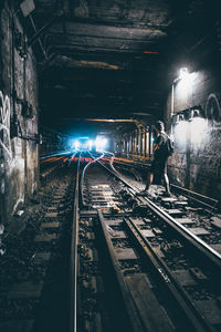 Man standing on railroad tracks