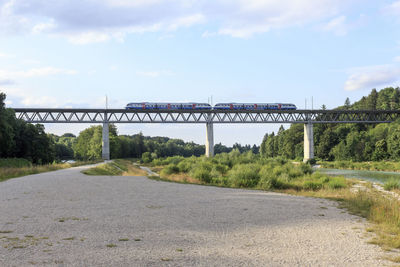 View of bridge over river against cloudy sky