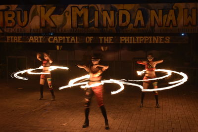 Full length of man with illuminated text at night