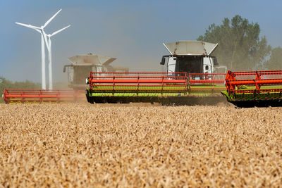 Traditional windmill on field against sky