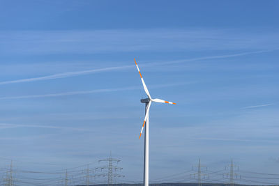 Wind turbine with three arms for electricity production standing in west germany. 