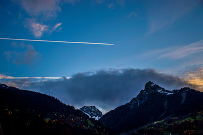 Scenic view of mountains against cloudy sky