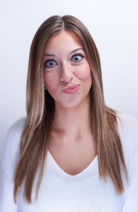 Portrait of beautiful young woman over white background