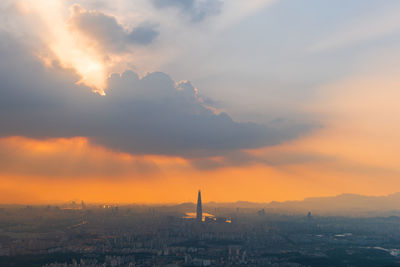 Scenic view of city against sky during sunset