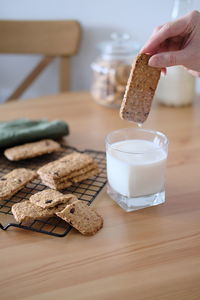 Dipping delicious healthy cereal cookies in milk