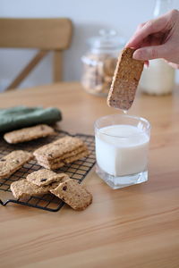 Cropped hand of person holding cookies