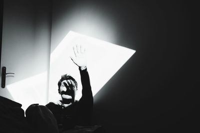 Sunlight falling on man in darkroom