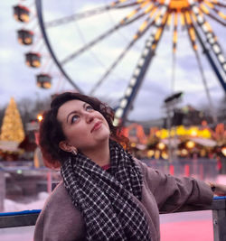 Portrait of young woman looking at amusement park