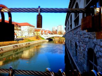 Bridge over river with buildings in background