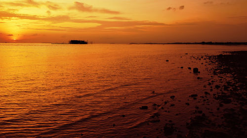 Scenic view of dramatic sky over sea during sunset