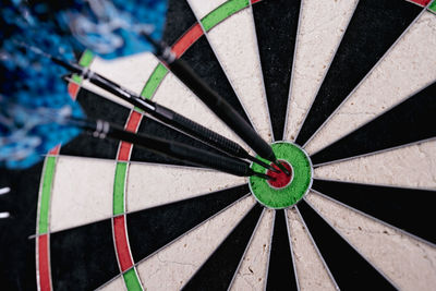 Three dart arrows hitting bullseye