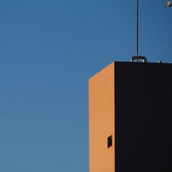 Low angle view of building against clear blue sky