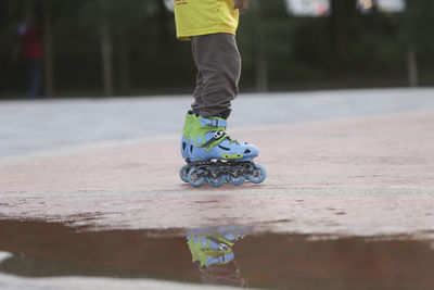 Low section of man skateboarding on street
