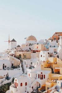 Buildings in city against clear sky