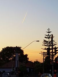 Silhouette trees against sky at sunset