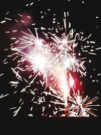 Low angle view of firework display at night