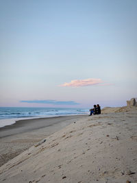 Scenic view of beach against sky during sunset