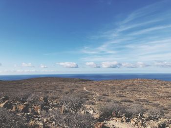 Scenic view of sea against blue sky