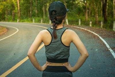 Rear view of man standing on road